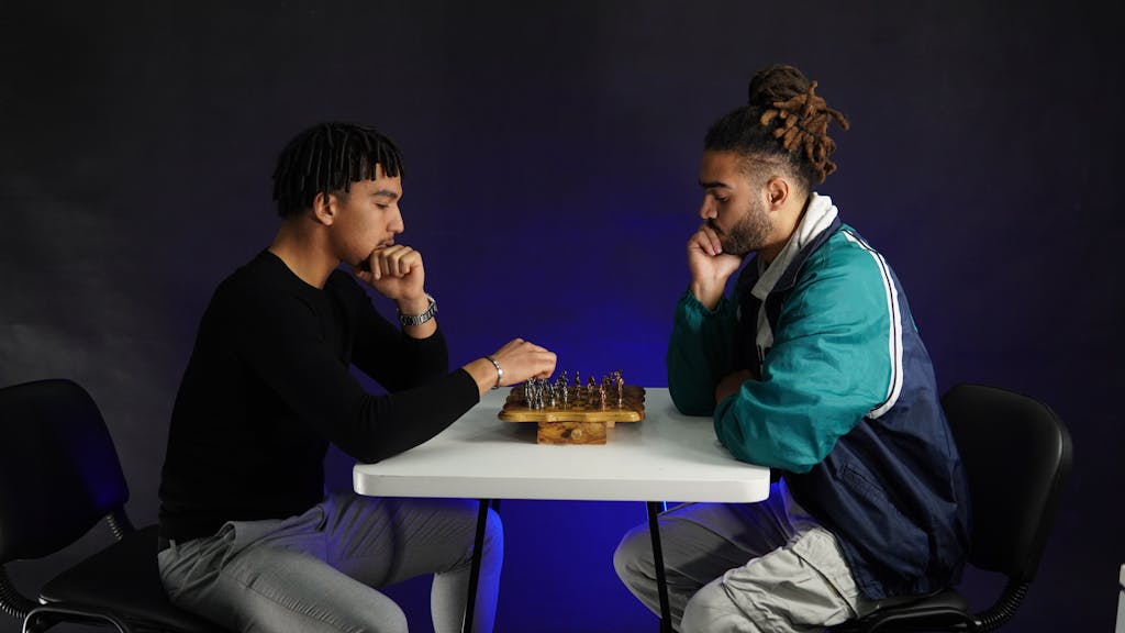 Chicago Cubs vs Dodgers Match Player Stats Two adults deeply engaged in a strategic chess match indoors, fostering concentration.