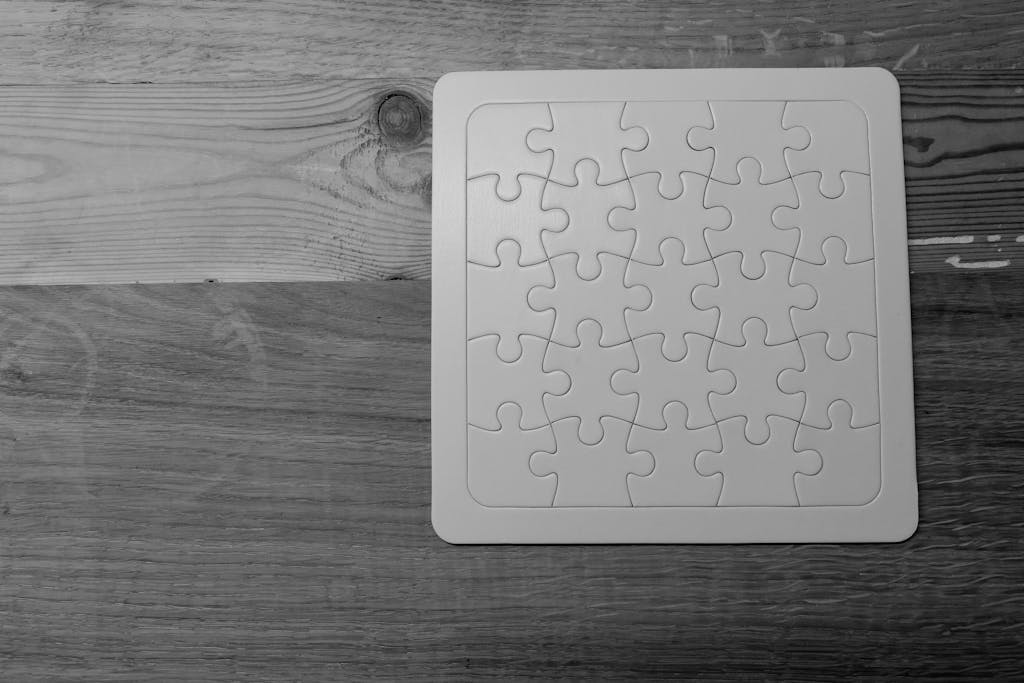 VirtusPlays Black and white image of a completed puzzle on a wooden table.