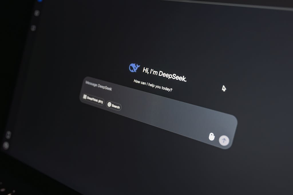 aiotechnical.com Close-up of DeepSeek AI chat interface on a laptop screen in low light.