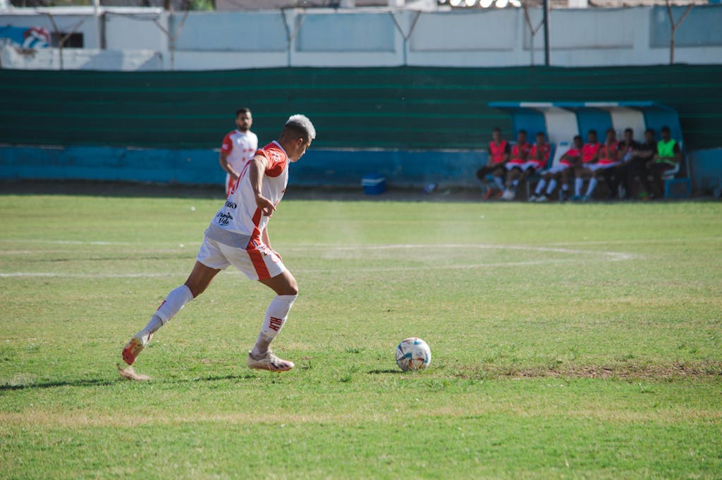 Miami Dolphins vs Cleveland Browns Match Player Stats Male soccer player in action on the field during a sunny day match.