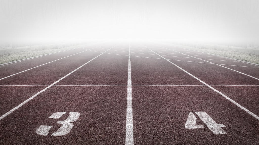 Sixmagazine A foggy track field with visible lane numbers and white lines.