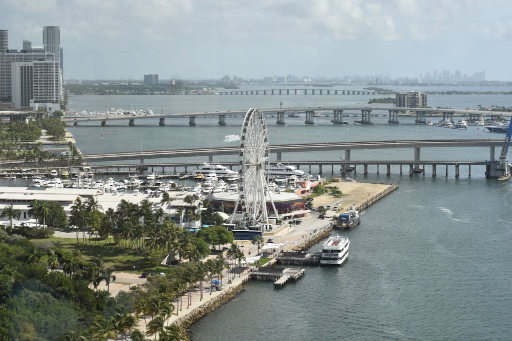 Chicago Cubs vs Miami Marlins: Player Stats Aerial shot of Miami's Ferris Wheel and waterfront with bridges and city skyline in view.