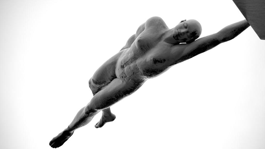 Lufanest Artistic black and white photograph of a nude figure sculpture displaying strength and motion.