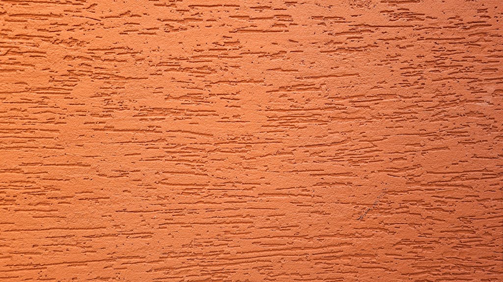 hormita Close-up of an orange textured wall surface in Campinas, Brazil, showing a rough pattern.