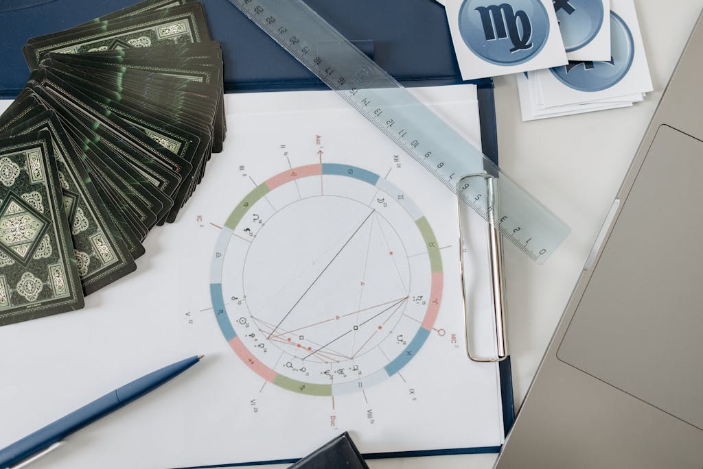 Nueraji vs Crosbie Prediction Flat lay of astrology tools, including tarot cards and a natal chart, on a desk.