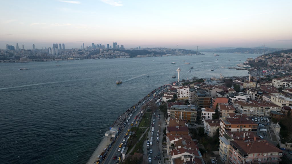 Ibomma1.com Scenic aerial view of İstanbul's Bosphorus at sunset, showcasing city skyline and waterway.