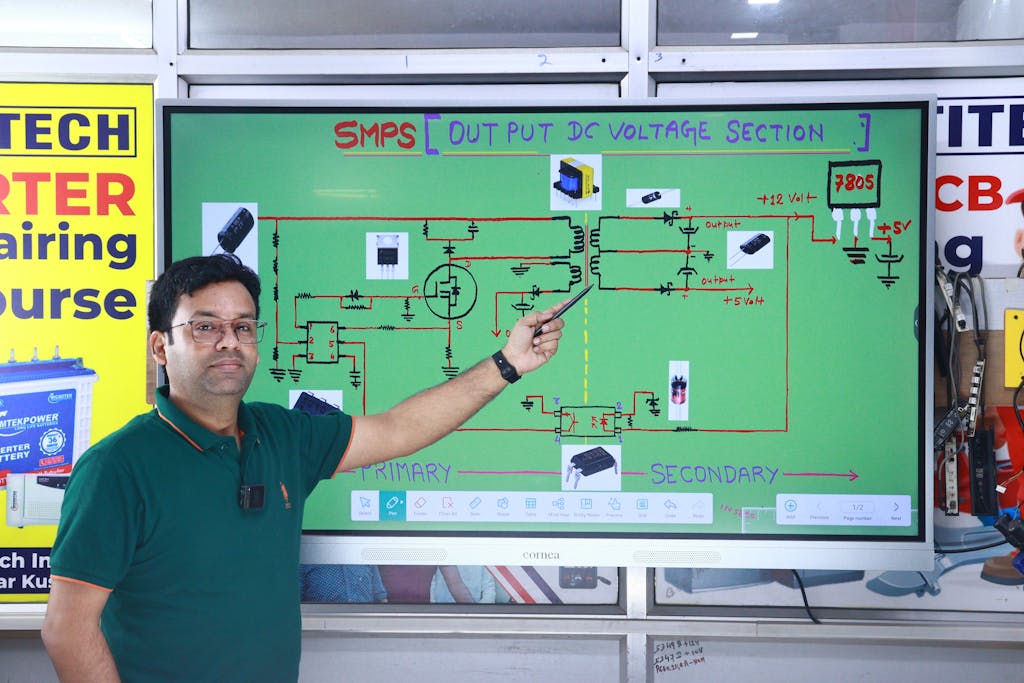 Kongotech org Instructor explaining SMPS voltage section diagram during AC repair course in New Delhi.