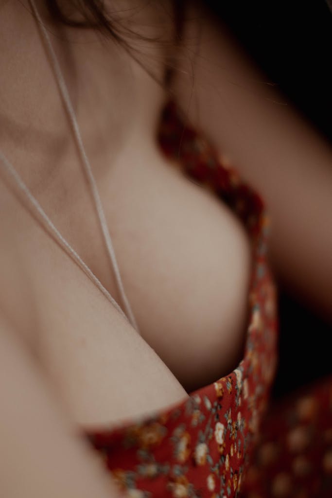 Uitly Intimate close-up of a red floral top highlighting feminine elegance and style.